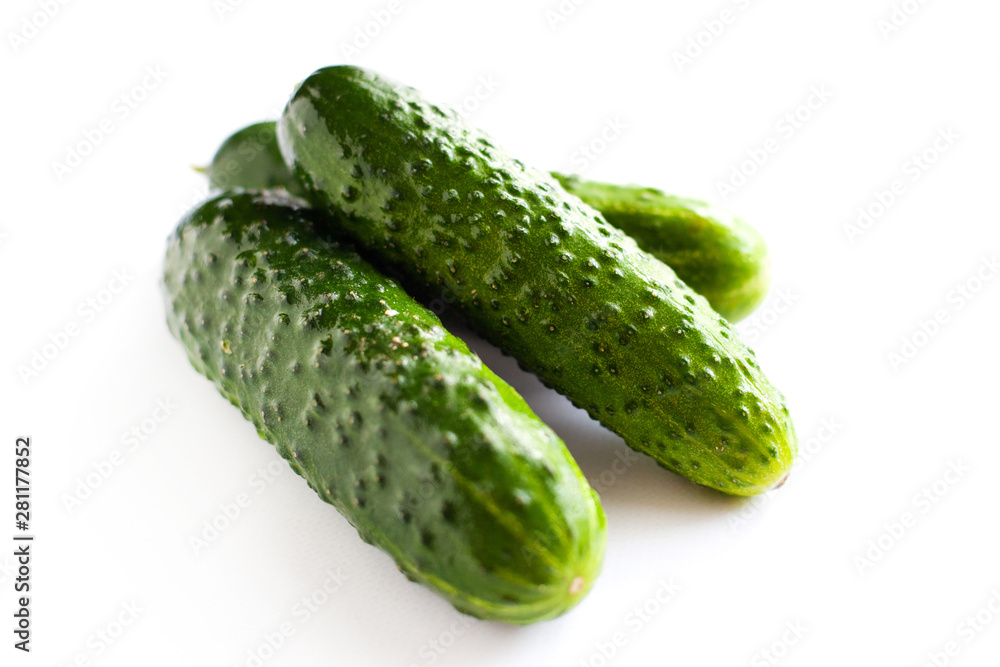 small gherkins, delicious fresh cucumbers on a white background small gherkins, delicious fresh cucumbers on a white background