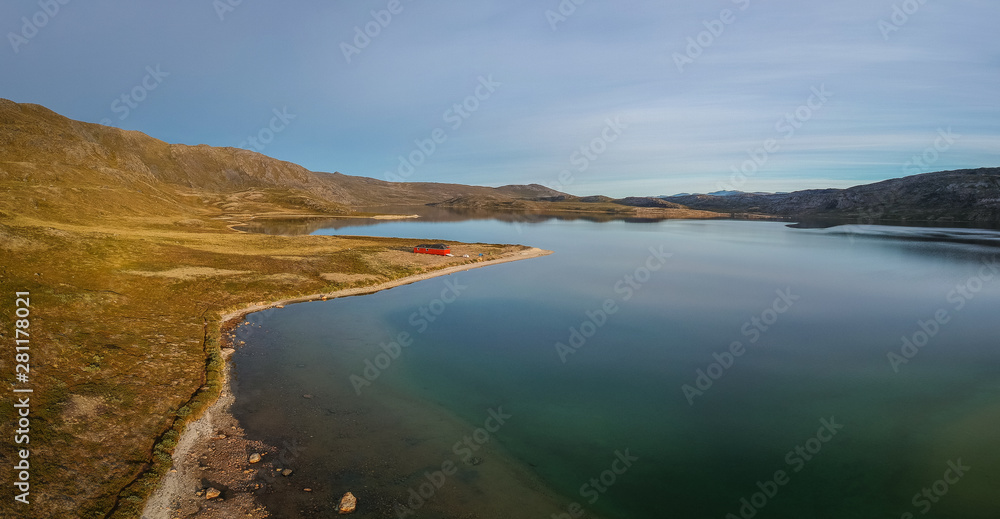 Fototapeta premium Golden morning light, Lake Amitsorsuaq and the Canoe Centre Hut on the Arctic Circle Trail in Greenland.