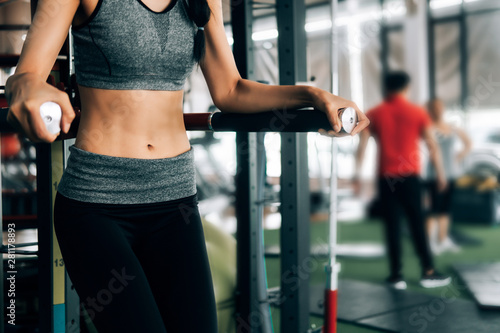 sport woman at fitness gym club doing exercise for body with exercise machine and showing muscle bodybuilding, fitness concept, sport concept