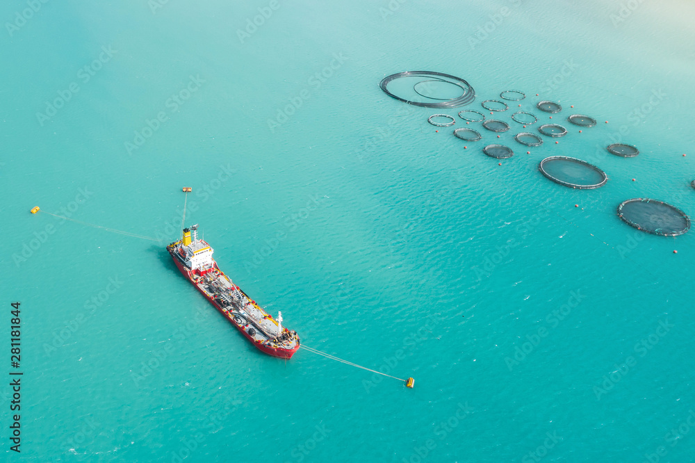 Φωτογραφία Aerial view cargo tanker moored in the bay, near the farm for growing fish