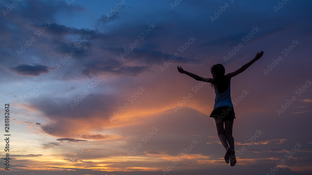 Silhouette of free woman enjoying freedom feeling happy at sunset. Serene relaxing woman in pure happiness Silhouette of free woman enjoying freedom feeling happy at sunset. Serene relaxing woman in pure happiness