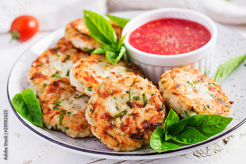 Delicious rice and chicken meat patties with garlic tomato sauce. Diet food.