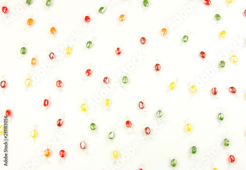 lot of colorful candy randomly scattered on a white background, concept of fun child party or birthday