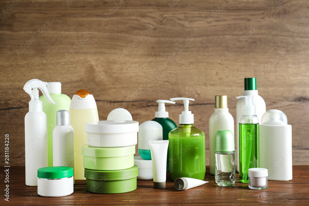 Different body care products on table against wooden background Different body care products on table against wooden background