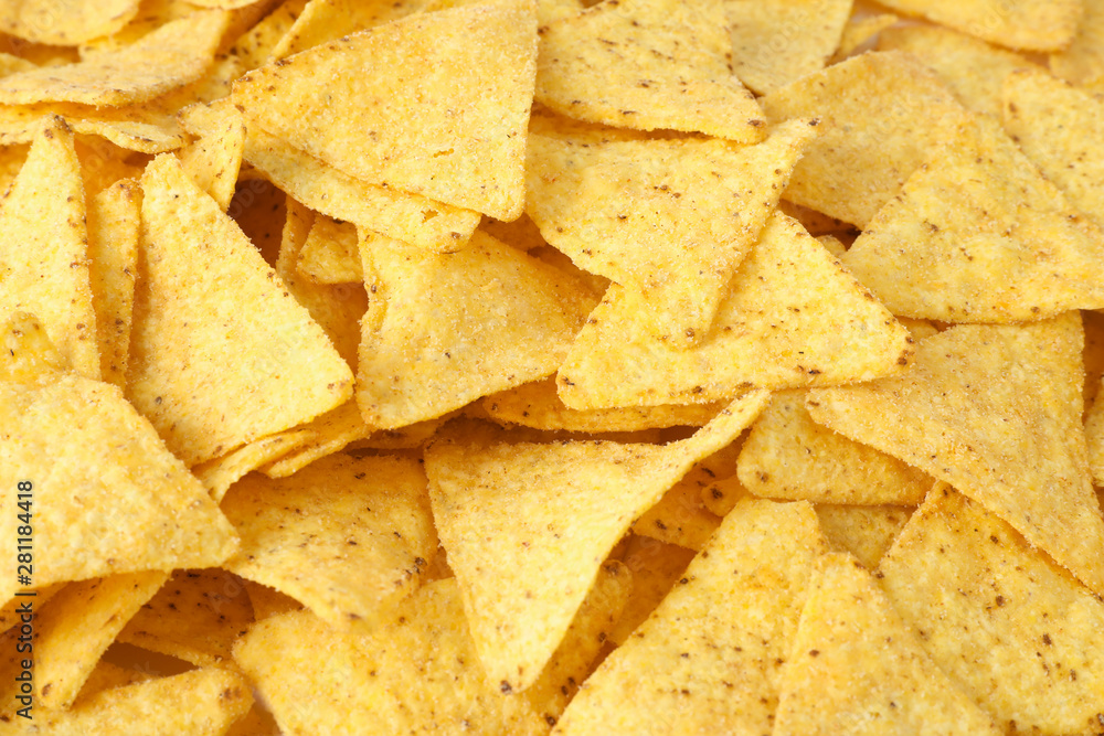 Tasty Mexican nachos chips as background, closeup