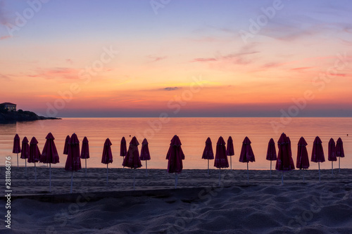 early morning on the beach with sea views and umbrellas on the shore