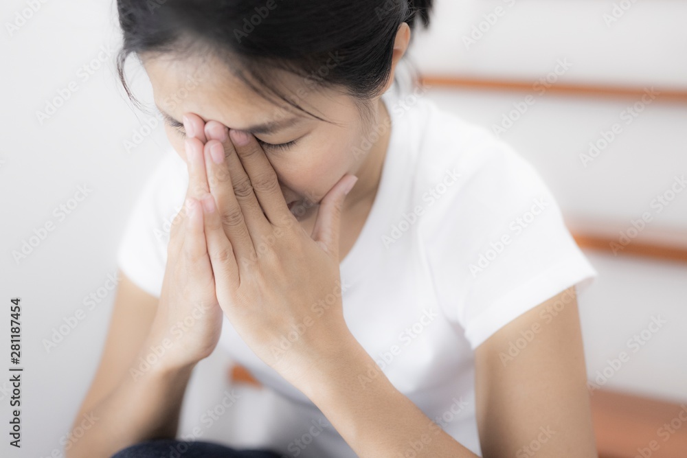 The depression woman alone sitting on staircase she thought so much and headaches, eye pain.
