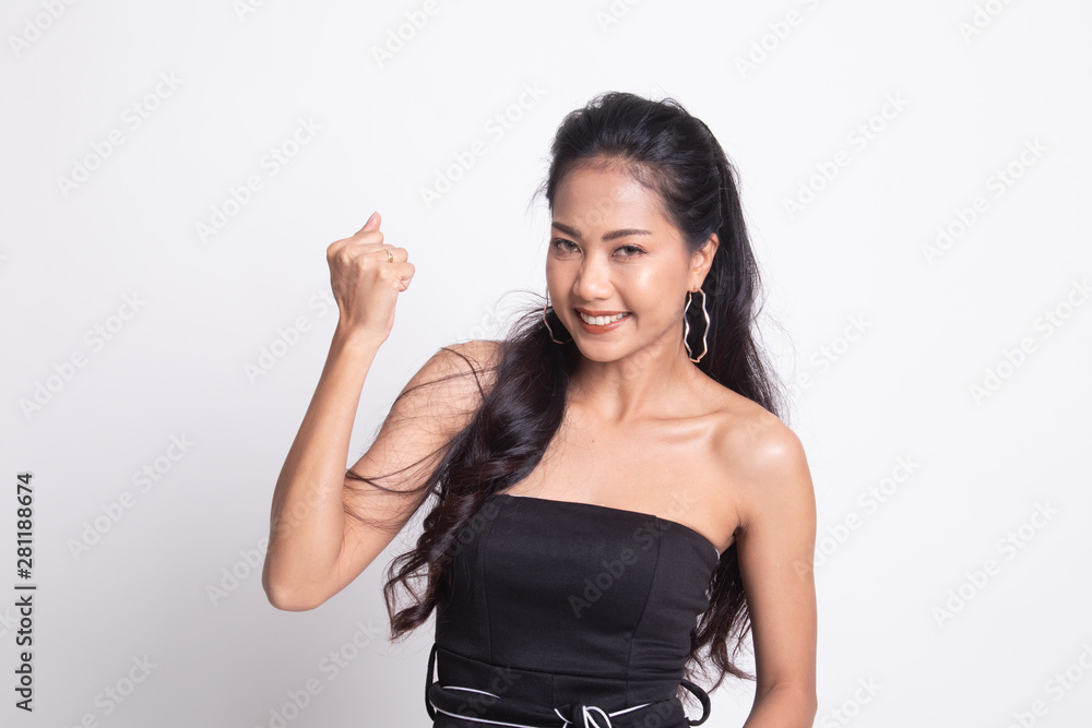 Successful young Asian woman hold fist up Successful young Asian woman hold fist up