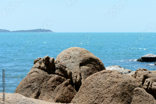Closeup view of sea stone on a background of blue sea