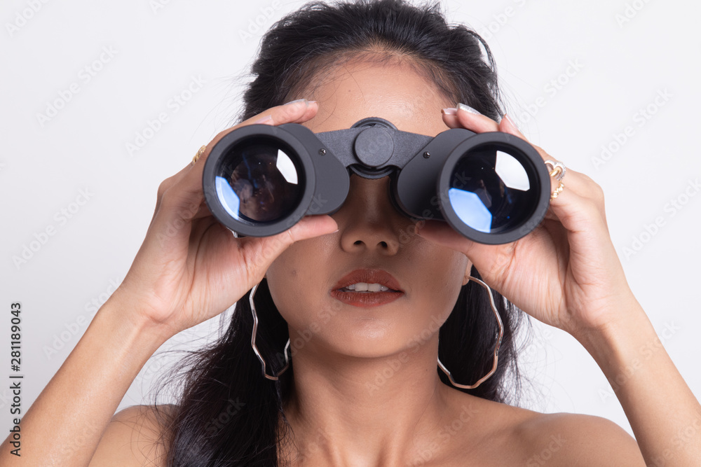 Young Asian woman with binoculars. Young Asian woman with binoculars.