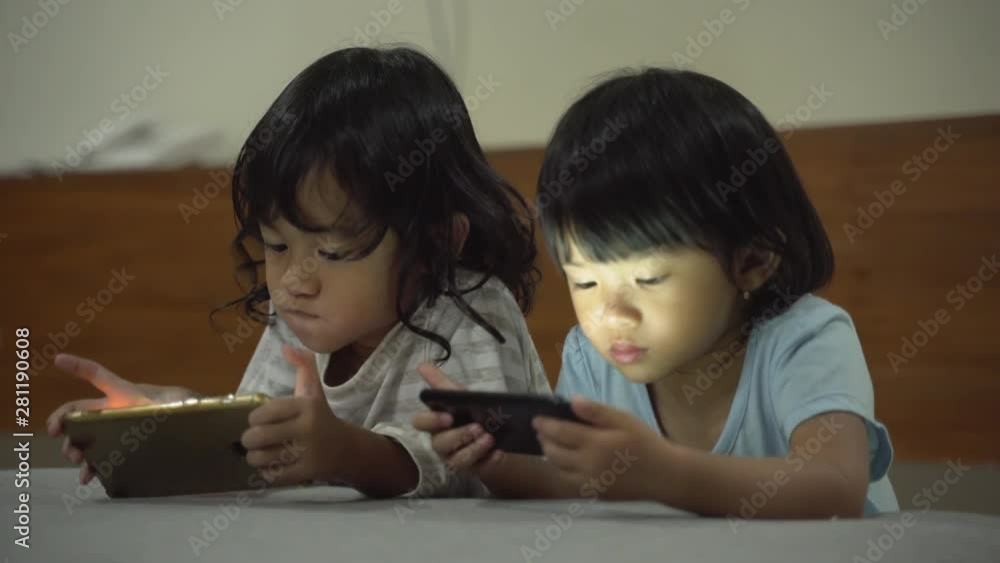 gadget addiction. portrait of two kids with smartphone gadget addiction. portrait of two kids with smartphone