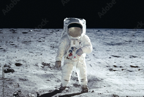 Fototapeta The astronaut goes across the Moon, in a white space suit Elements of this image