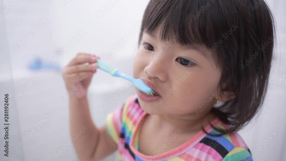 toddler independently brush her own teeth in the bathroom looking at the mirror toddler independently brush her own teeth in the bathroom looking at the mirror