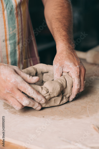Man creating pottery in his studio
