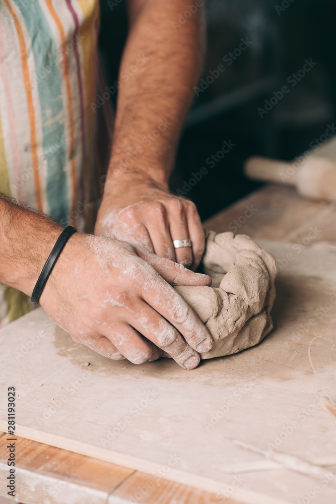 Man creating pottery in his studio