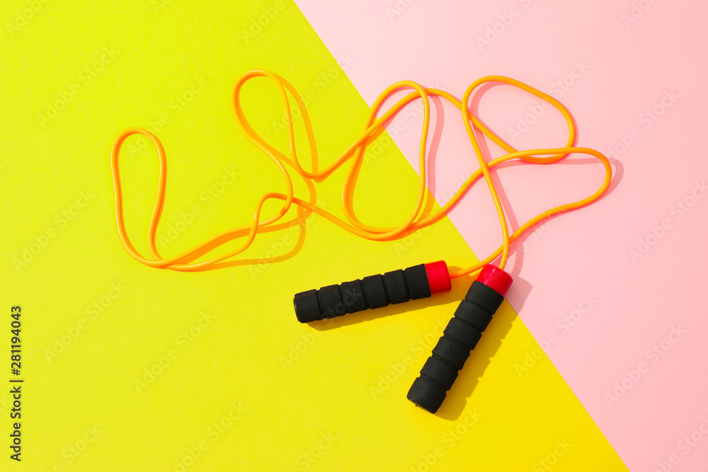 Jump rope on two tone background, space for text Jump rope on two tone background, space for text