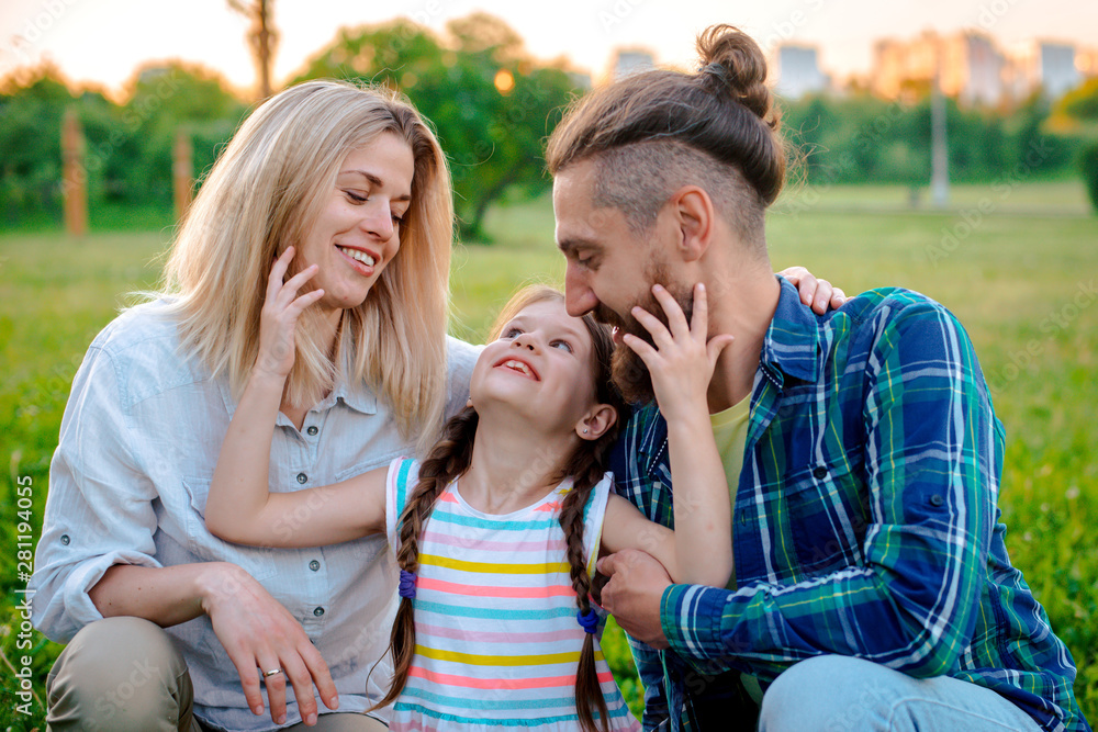 Happy young family spending time together outside in green nature. Happy young family spending time together outside in green nature.