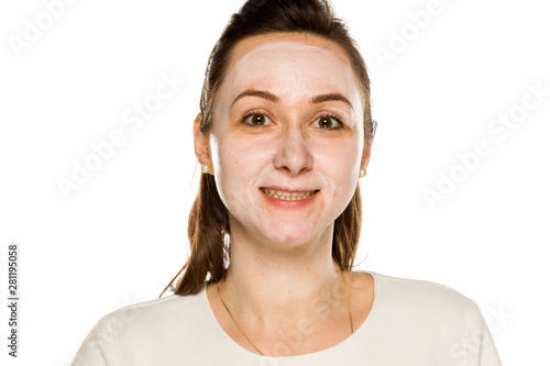 happy woman posing with face cream on white background