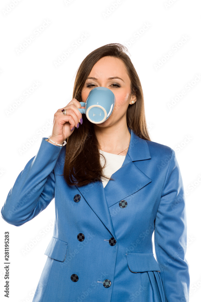 Young business woman drink from a mug on white background Young business woman drink from a mug on white background