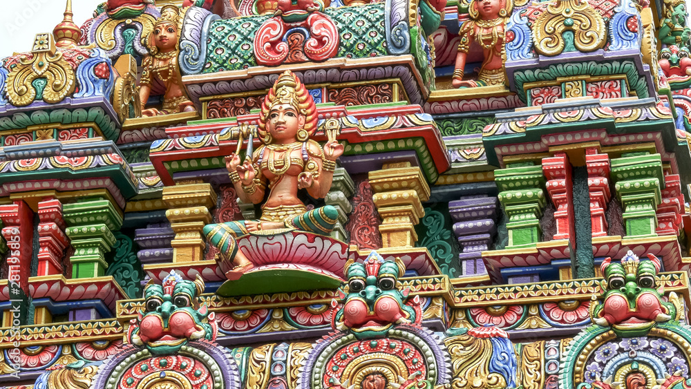 BANGKOK, THAILAND- JUNE, 21, 2017: close up of a statue of a four armed hindu god at sri maha mariamman temple