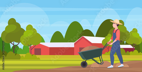 gardener man pushing wheelbarrow loaded with soil farmer working agricultural planting harvesting gardening eco farming concept farmland countryside landscape full length horizontal