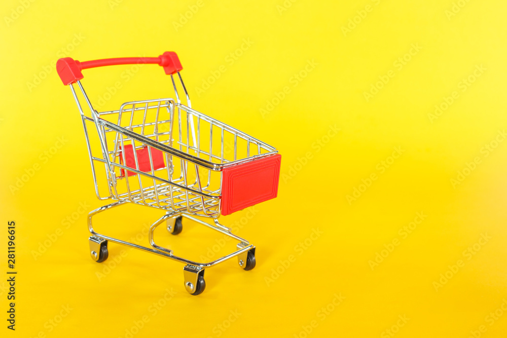 red shopping cart on yellow background.