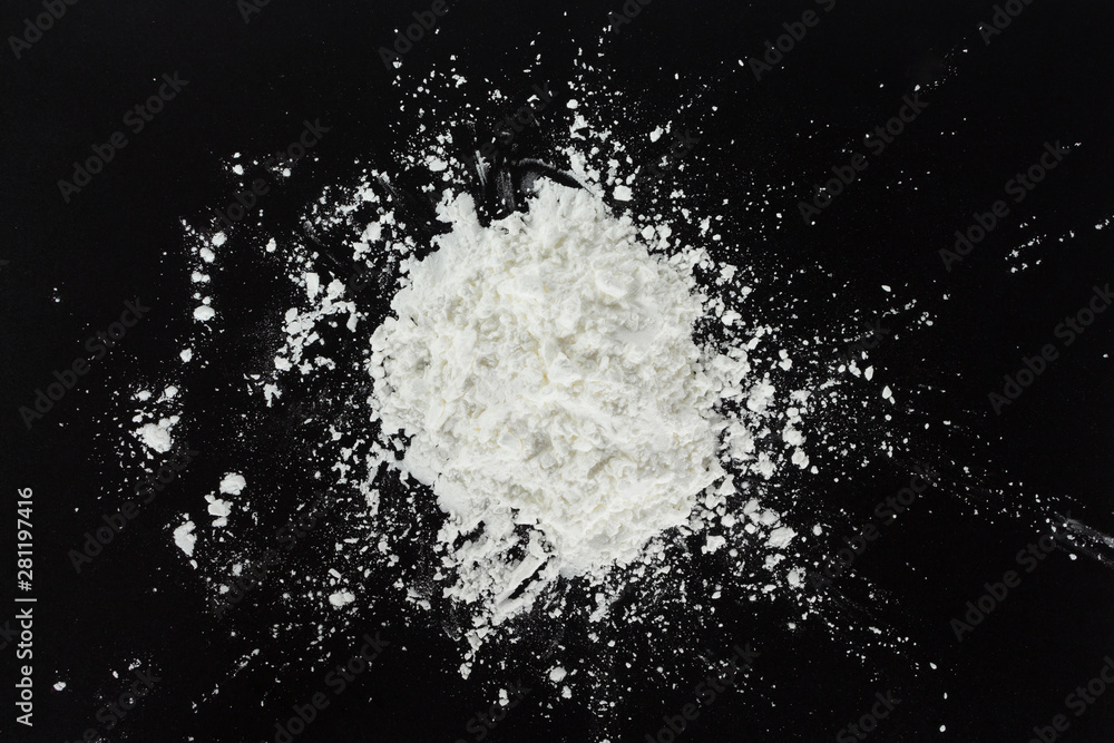 white flour cooking on black background. white flour cooking on black background.