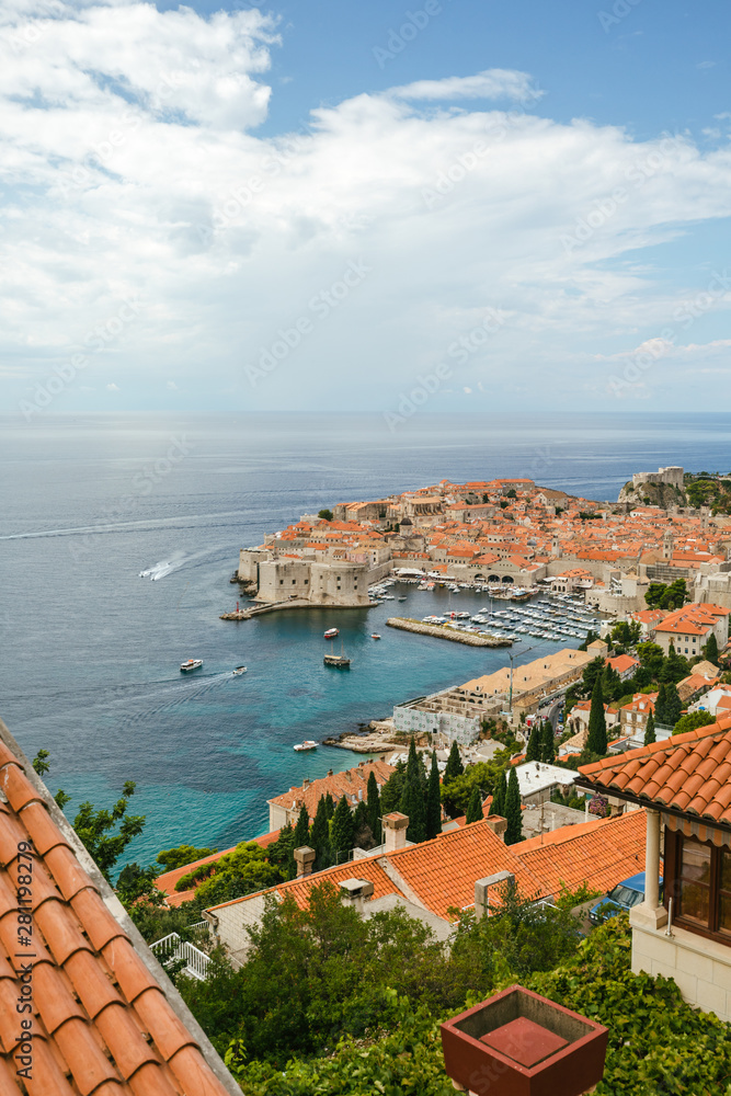 Beautiful townscape of Dubrovnik city in Croatia, panorama view. Old town and blue bay with boats