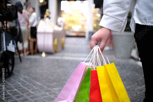 Asian girls holding sale shopping bags. consumerism lifestyle concept in the shopping mall.