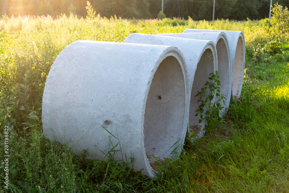 four reinforced concrete rings lie on the grass four reinforced concrete rings lie on the grass