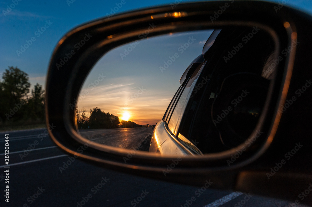 sunset in the rear view mirror of a car sunset in the rear view mirror of a car