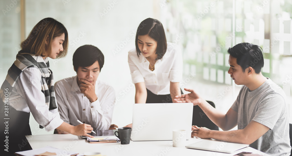 Motivated startup team consulting their startup plan Motivated startup team consulting their startup plan