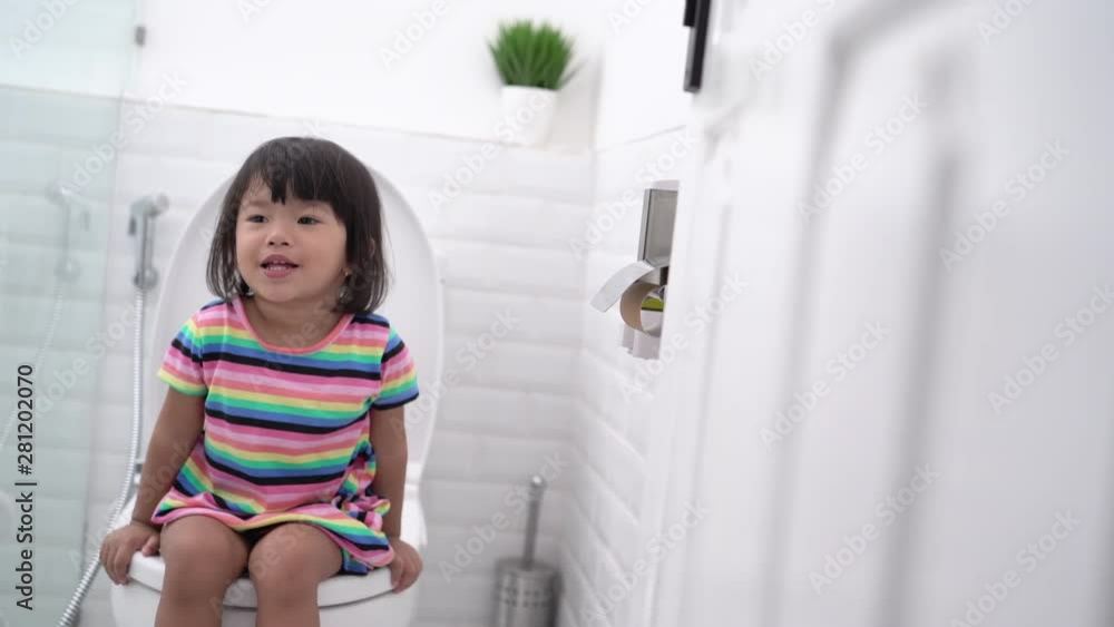 pooping in the toilet. cute asian kid push it hard while sitting on toilet pooping in the toilet. cute asian kid push it hard while sitting on toilet