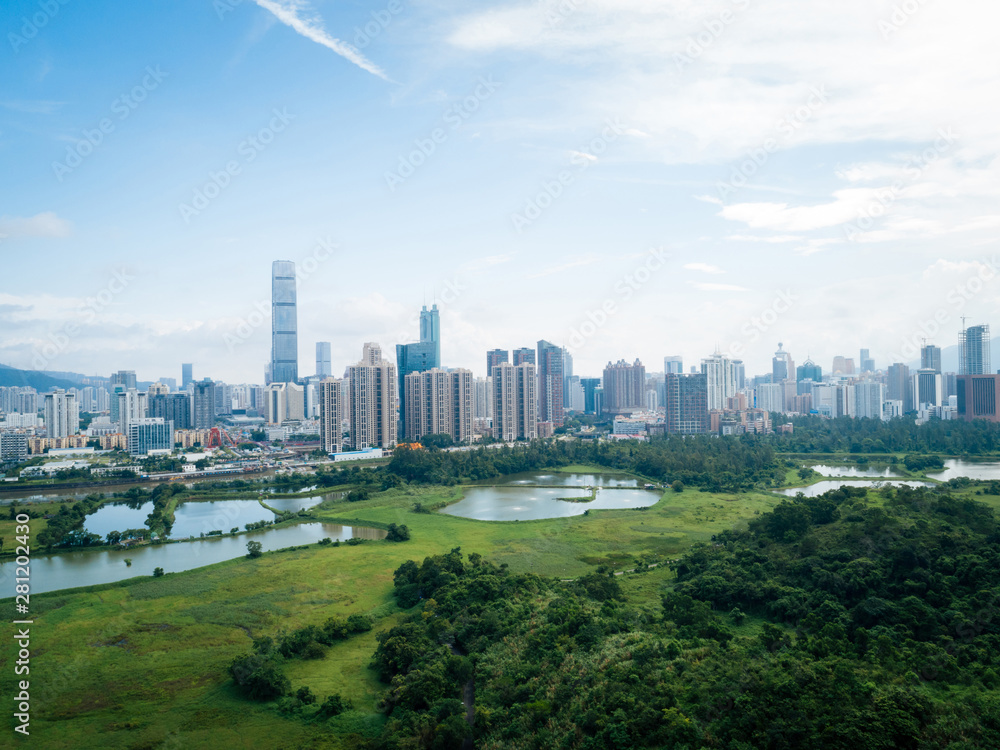 Fototapeta premium Rural green fields with fish ponds between Hong Kong and skylines of Shenzhen,China