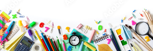 Set of different stationery, alarm clock and supplies on white background. Back to school concept. Banner format. Top view.