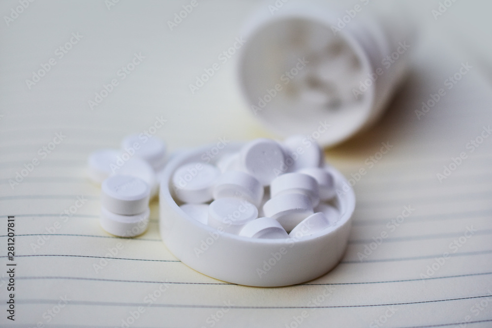 White pills placed on the table White pills placed on the table