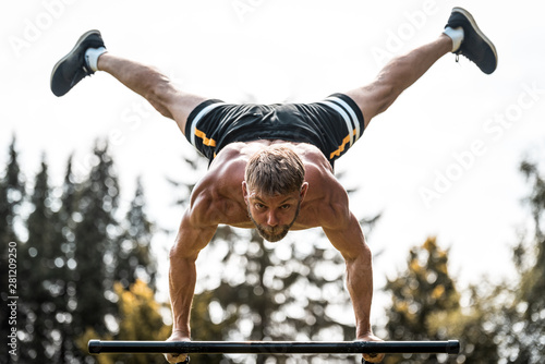 Obraz na plátně calisthenics hand stand fitness, sport, training and lifestyle concept - young m