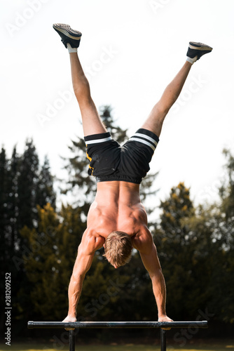 Obraz na plátně calisthenics hand stand fitness, sport, training and lifestyle concept - young m