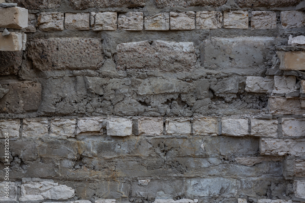 Brick wall with destroyed masonry