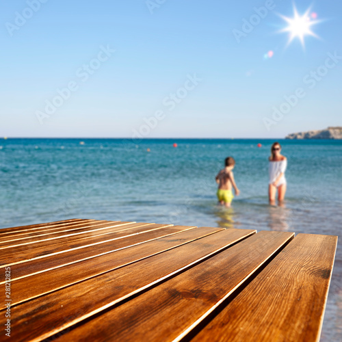 Desk of free space and beach background 