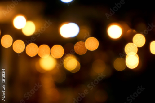 Abstract blurred and bokeh light bubs reflection lighting of small pub in the city at the night time. © Atiwat
