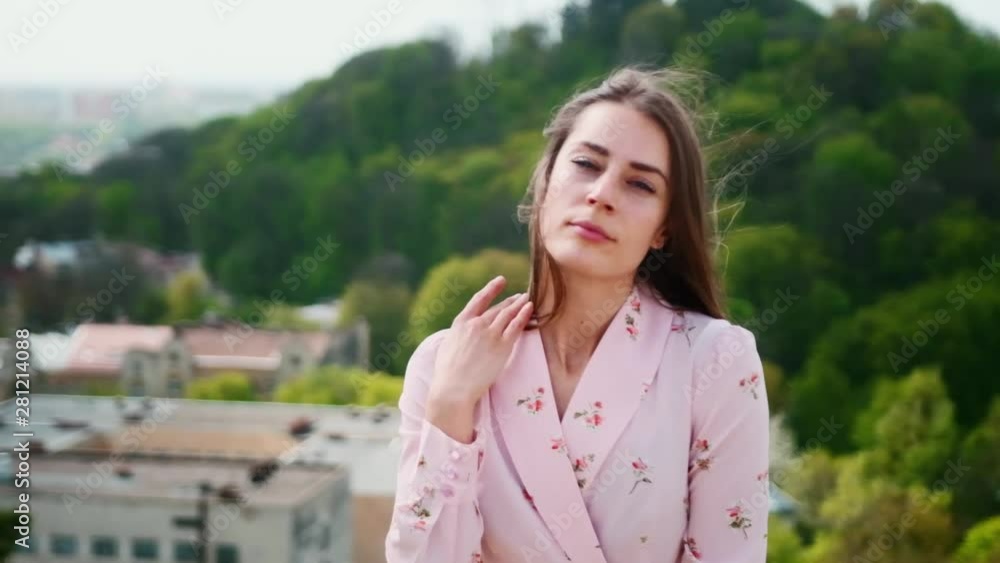Nice looking pretty caucasian girl staying in wonderful highland nature landscape. Portrait of fascinated girl with lovely hair and dress dreaming and observing summer scenery.