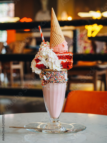 Pink freak shake with ice cream, cake and whipped cream photo