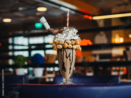 Chocolate freak shake with popcorn, marshmallow and whipped cream photo