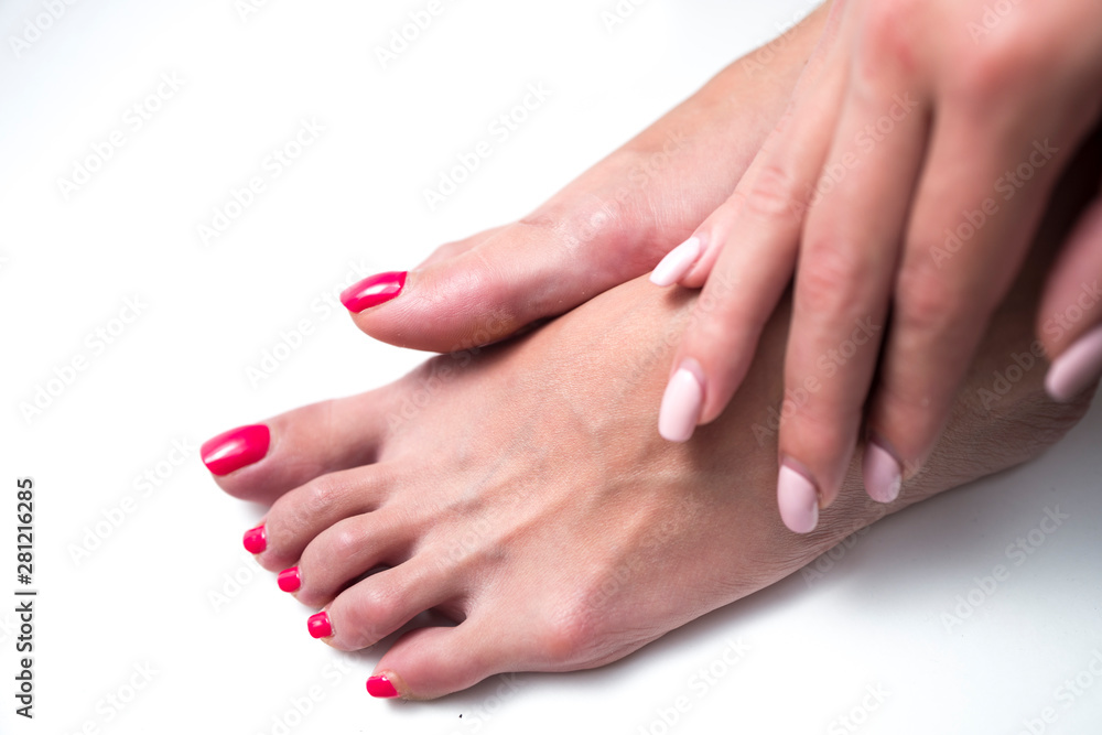 Beautiful woman's feets with a red nails.