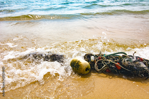 Canvastavla Broken seines or trawls or fishnets lay on the tropical beach in Malaysia