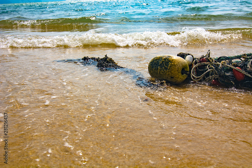 Broken seines or trawls or fishnets lay on the tropical beach in Malaysia photo