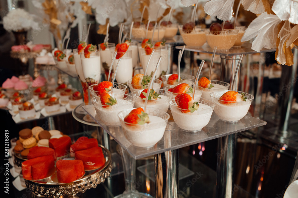 Candy bar. Table with strawberry deserts. Sweet table for banquets, weddings, parties.