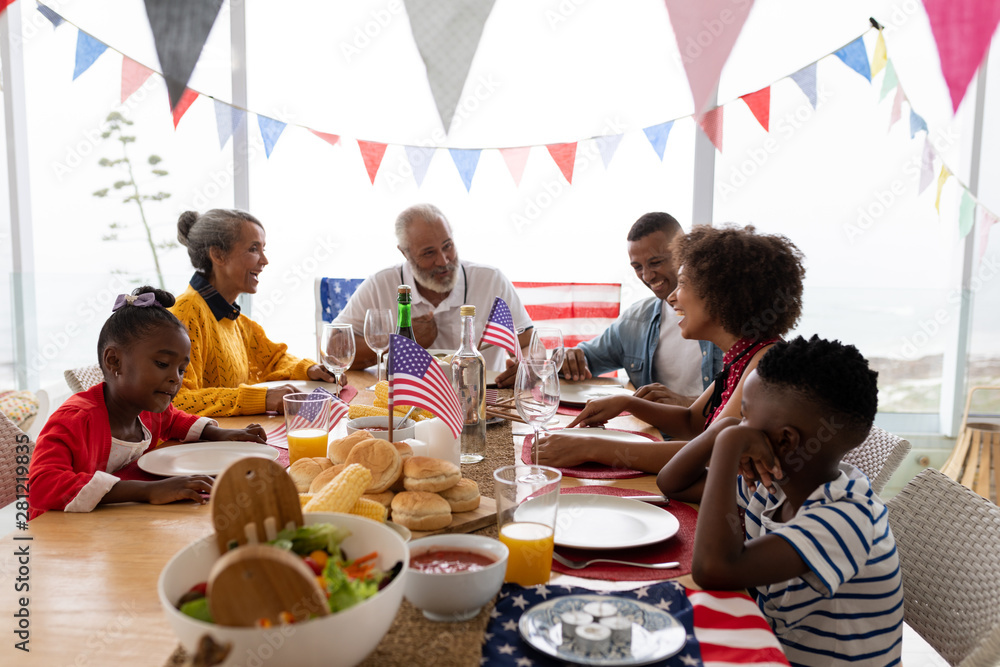 Multi-generation family sitting together for having meal on a dining