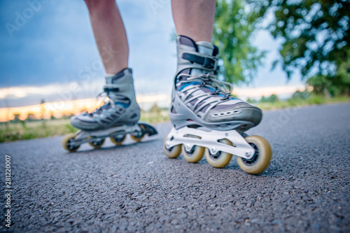 roller skates in action on the asphalt trail at freestyle races outside the city